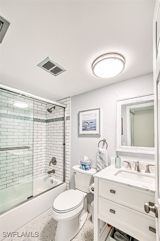 full bathroom with vanity, tile patterned floors, enclosed tub / shower combo, and toilet