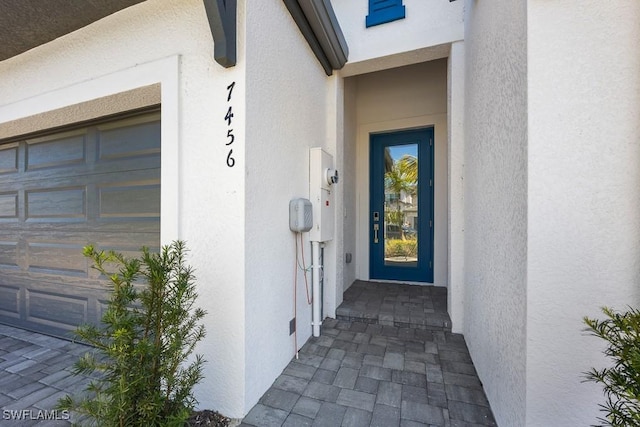 view of exterior entry with a garage