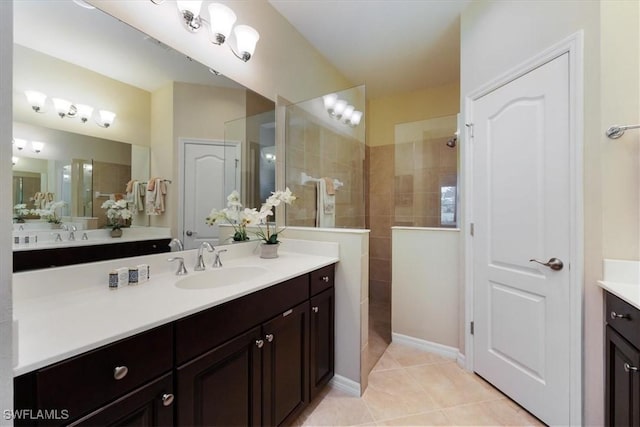 bathroom featuring vanity, tiled shower, and tile patterned floors