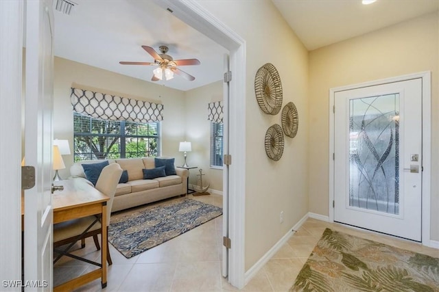 foyer entrance featuring light tile patterned flooring and ceiling fan