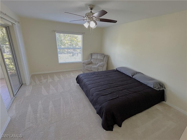 bedroom featuring multiple windows, light colored carpet, and ceiling fan