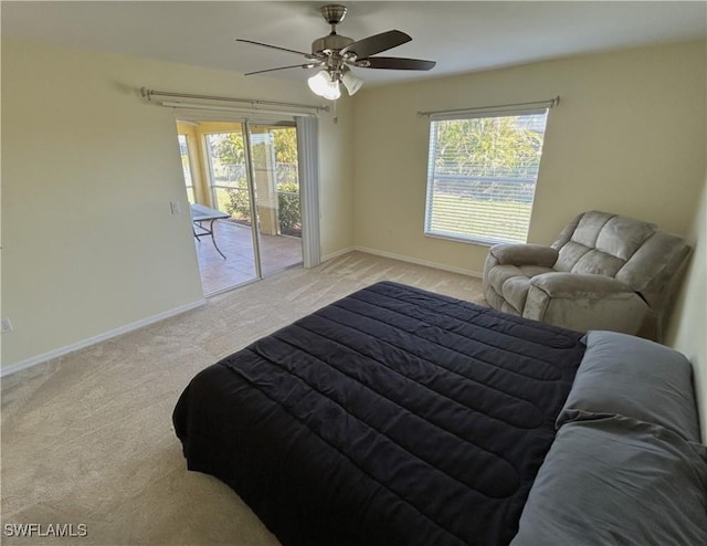 carpeted bedroom featuring multiple windows, access to exterior, and ceiling fan