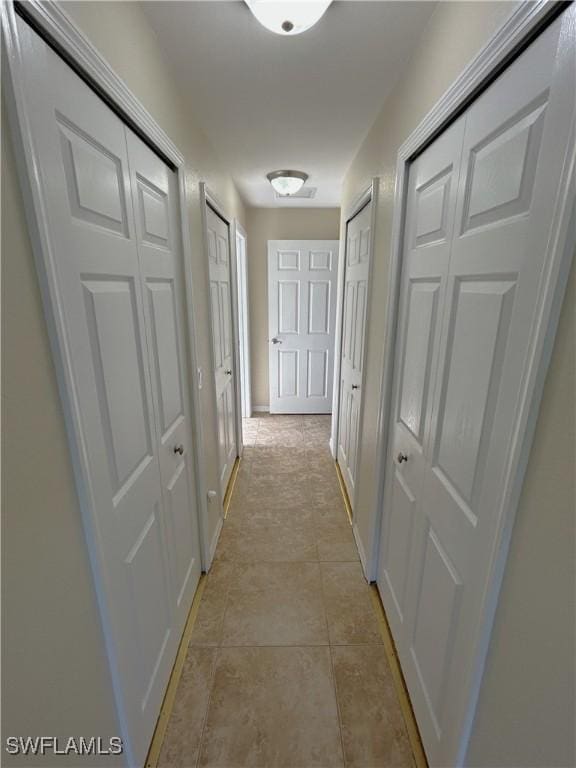 hall with light tile patterned flooring