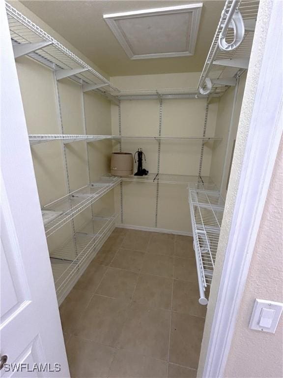 spacious closet with tile patterned flooring