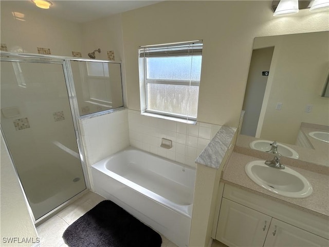 bathroom with plus walk in shower, tile patterned floors, and vanity