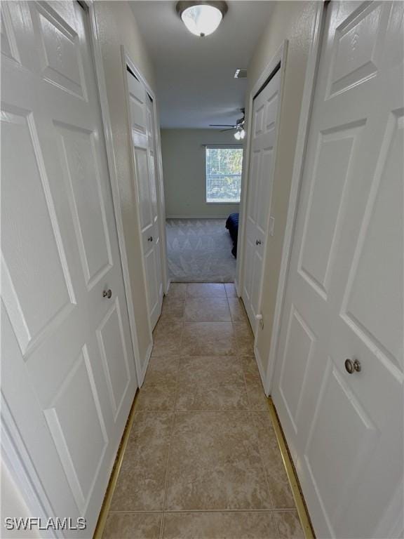 hall featuring light tile patterned floors