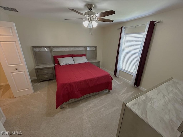 bedroom with ceiling fan and light carpet