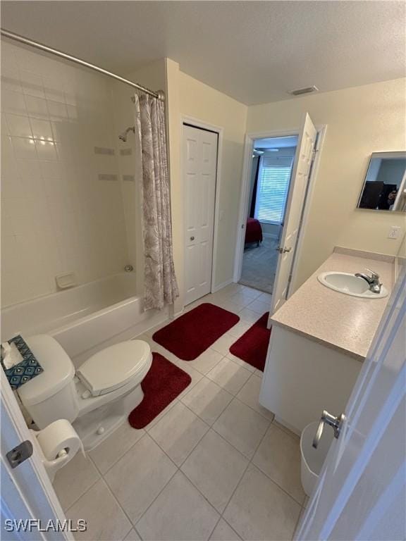 full bathroom with vanity, toilet, tile patterned floors, a textured ceiling, and shower / bath combo with shower curtain