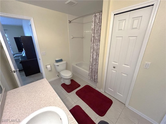 full bathroom featuring tile patterned flooring, vanity, toilet, and shower / bath combo with shower curtain