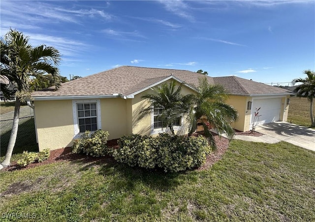 view of side of home featuring a garage and a yard