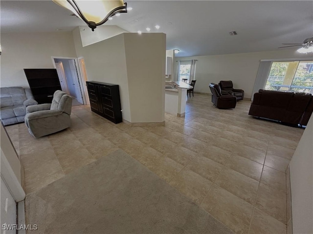 living room featuring lofted ceiling, plenty of natural light, and ceiling fan