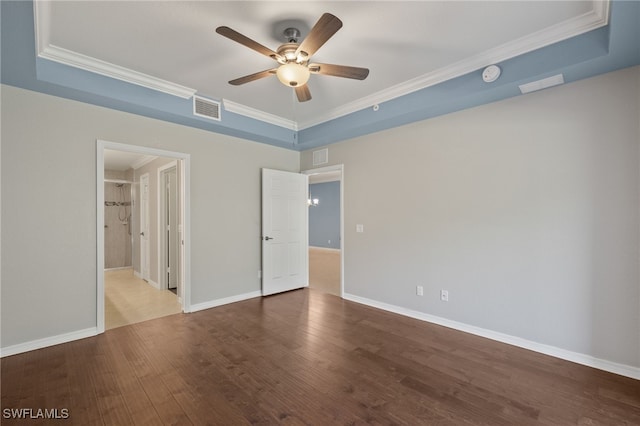 interior space featuring crown molding, hardwood / wood-style flooring, a raised ceiling, and ceiling fan