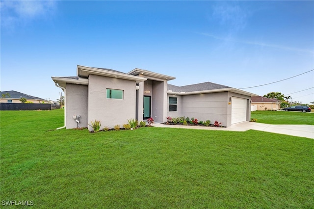 view of front of property featuring a garage and a front lawn