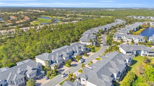drone / aerial view featuring a water view and a residential view