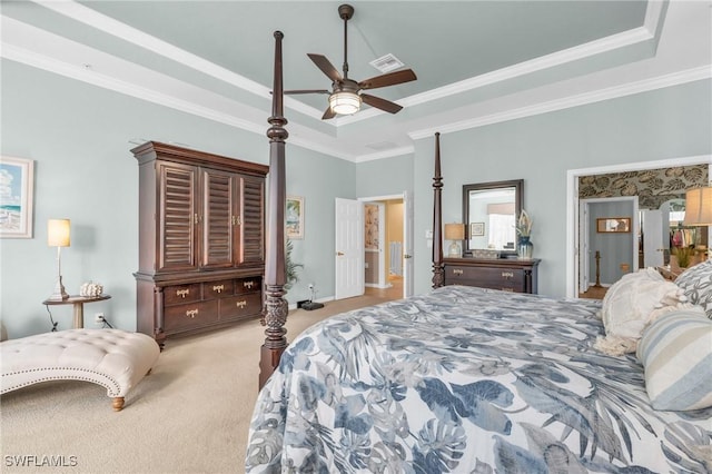 carpeted bedroom featuring crown molding, ceiling fan, and a tray ceiling