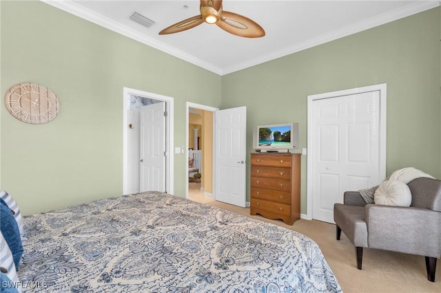 bedroom with crown molding, carpet flooring, visible vents, a ceiling fan, and a closet
