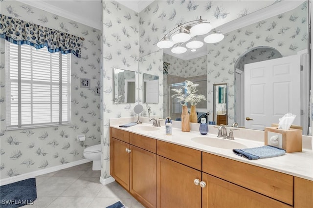 bathroom featuring tile patterned floors, toilet, ornamental molding, vanity, and a shower with door