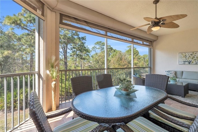 sunroom with ceiling fan and outdoor dining space