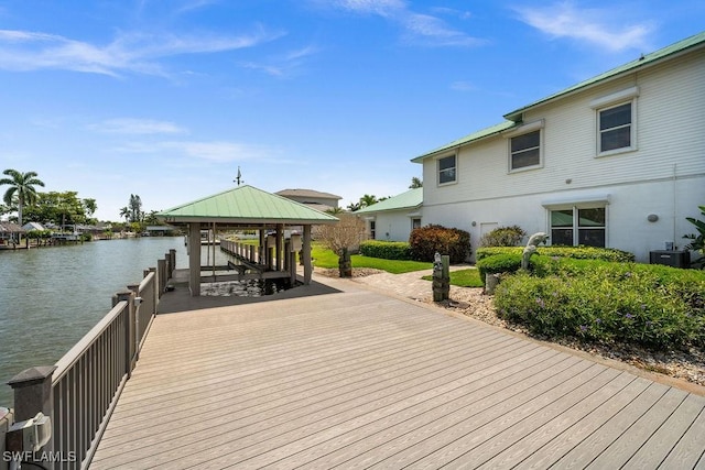 view of dock with a gazebo, central AC, and a water view