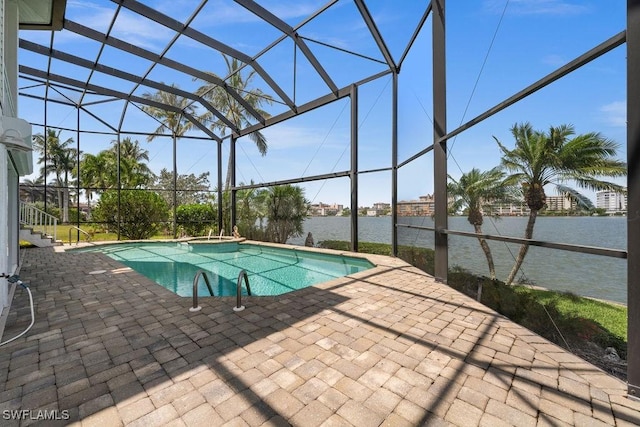 view of pool with a lanai, a patio, and a water view