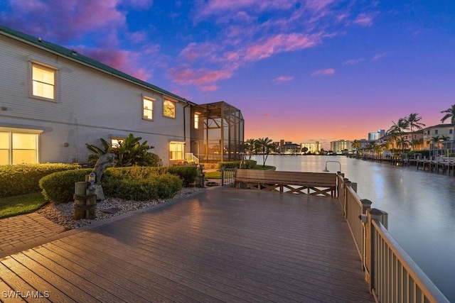 dock area featuring a water view and glass enclosure