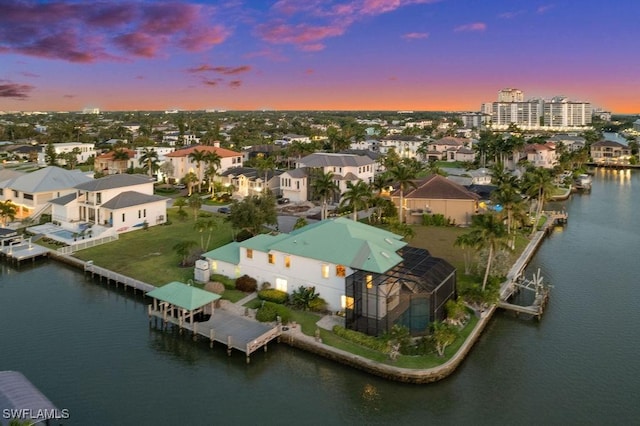 aerial view at dusk with a water view