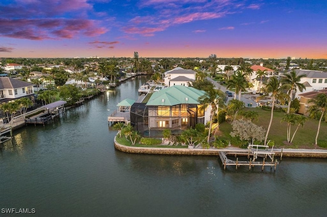 aerial view at dusk with a water view