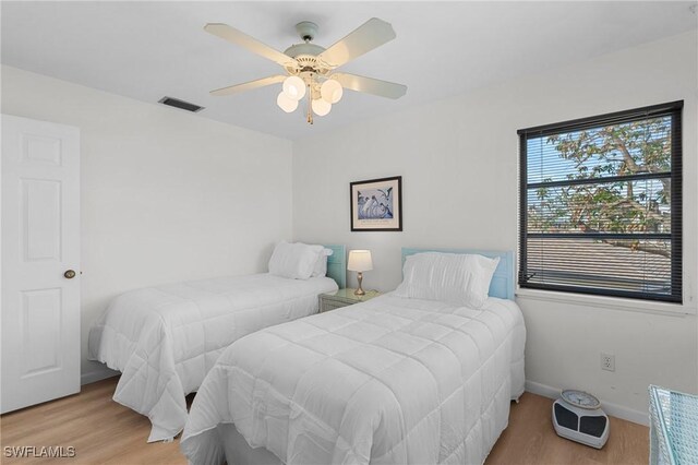 bedroom featuring hardwood / wood-style floors and ceiling fan