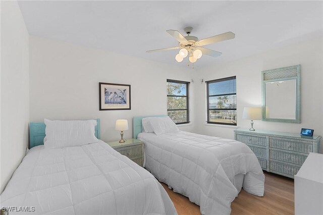 bedroom with ceiling fan and light wood-type flooring