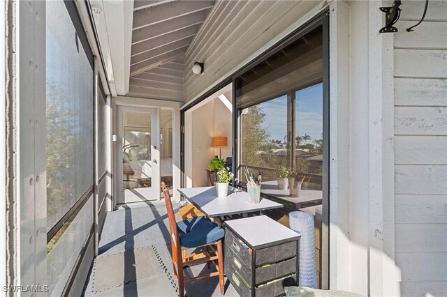 sunroom featuring lofted ceiling