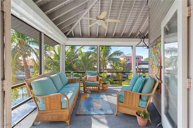 sunroom with lofted ceiling with beams and ceiling fan