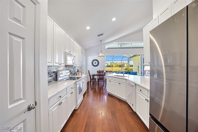 kitchen with white cabinetry, white appliances, and hanging light fixtures