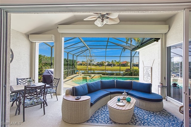 view of patio with ceiling fan, an outdoor hangout area, glass enclosure, and a hot tub