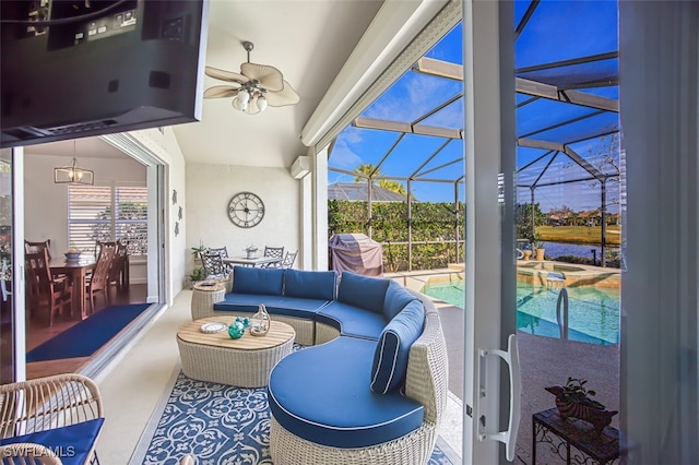 sunroom featuring ceiling fan