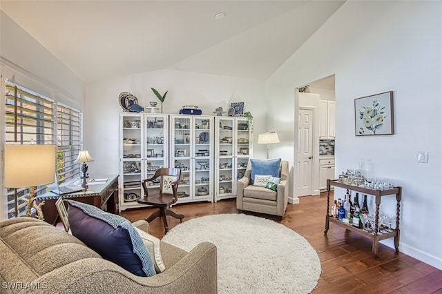 living room featuring hardwood / wood-style flooring and vaulted ceiling