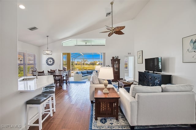 living room featuring ceiling fan, high vaulted ceiling, sink, and hardwood / wood-style floors