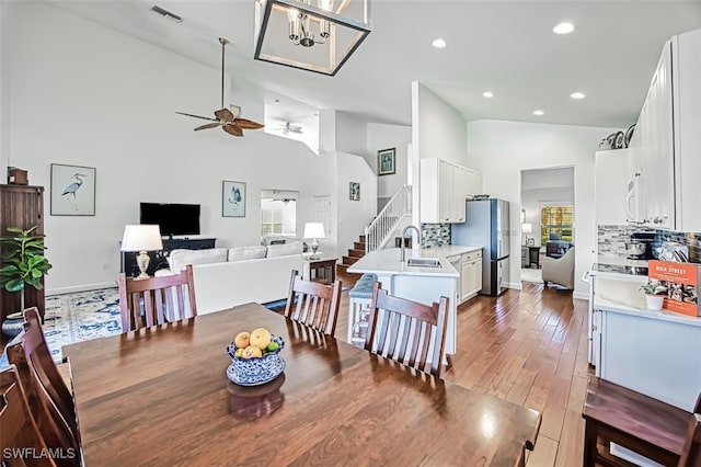 dining room with ceiling fan, plenty of natural light, sink, and hardwood / wood-style floors