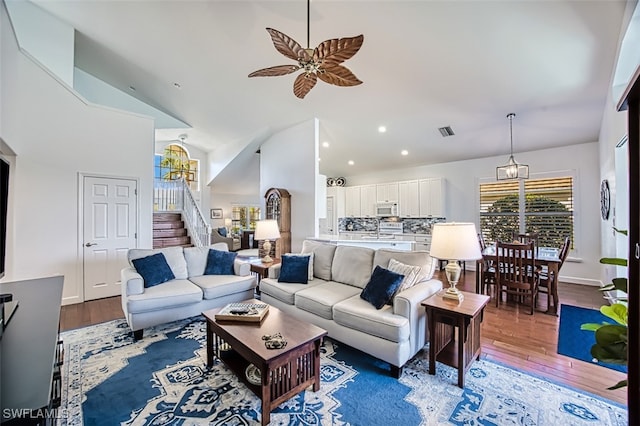 living room featuring hardwood / wood-style flooring, high vaulted ceiling, and ceiling fan