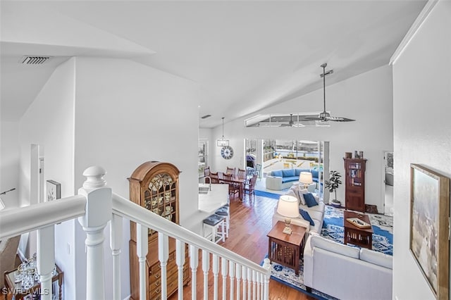 living room with hardwood / wood-style floors, vaulted ceiling, and ceiling fan