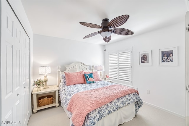 carpeted bedroom with ceiling fan and a closet