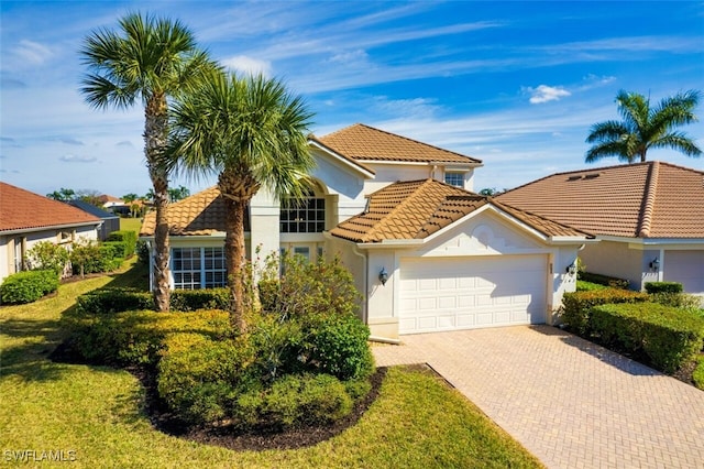 view of front facade with a garage and a front lawn