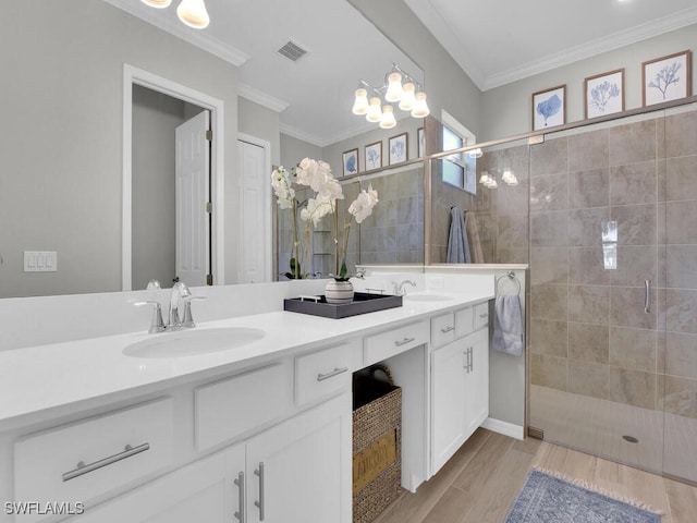 bathroom with hardwood / wood-style flooring, ornamental molding, an enclosed shower, and vanity