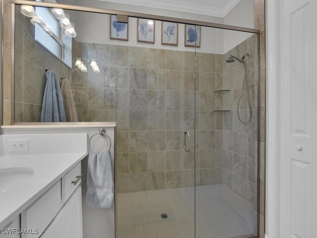 bathroom featuring vanity, crown molding, and a shower with door