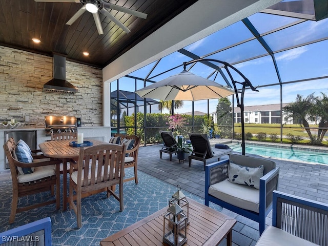 view of patio / terrace with an outdoor hangout area, a lanai, exterior kitchen, and area for grilling