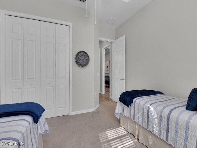 bedroom featuring light carpet and a closet