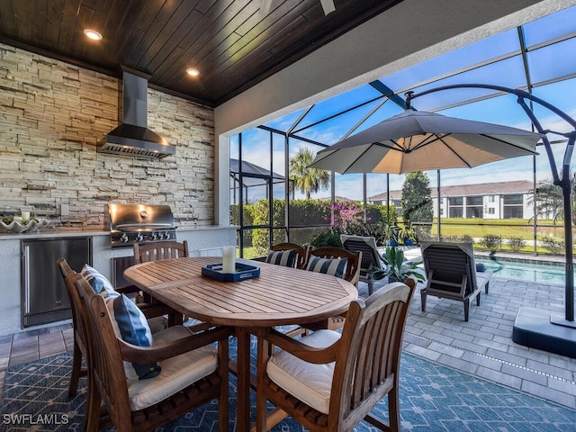 view of patio / terrace featuring area for grilling, a grill, and glass enclosure