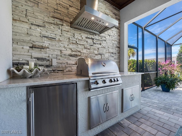 view of patio / terrace featuring an outdoor kitchen, a grill, and a lanai