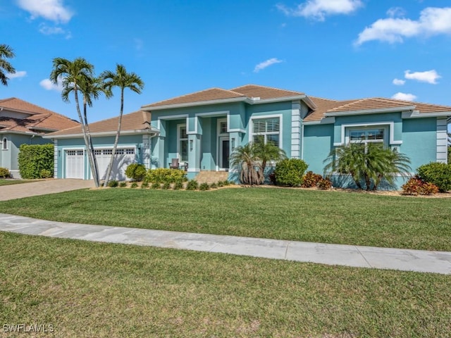 view of front of property featuring a garage and a front lawn