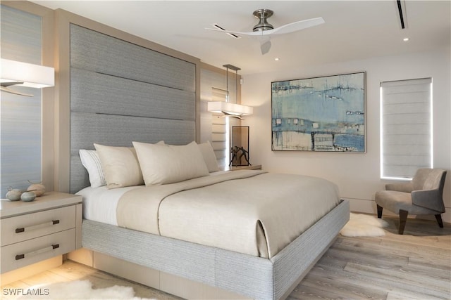 bedroom with ceiling fan and light wood-type flooring