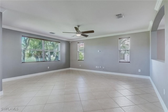 spare room with crown molding, ceiling fan, and light tile patterned floors